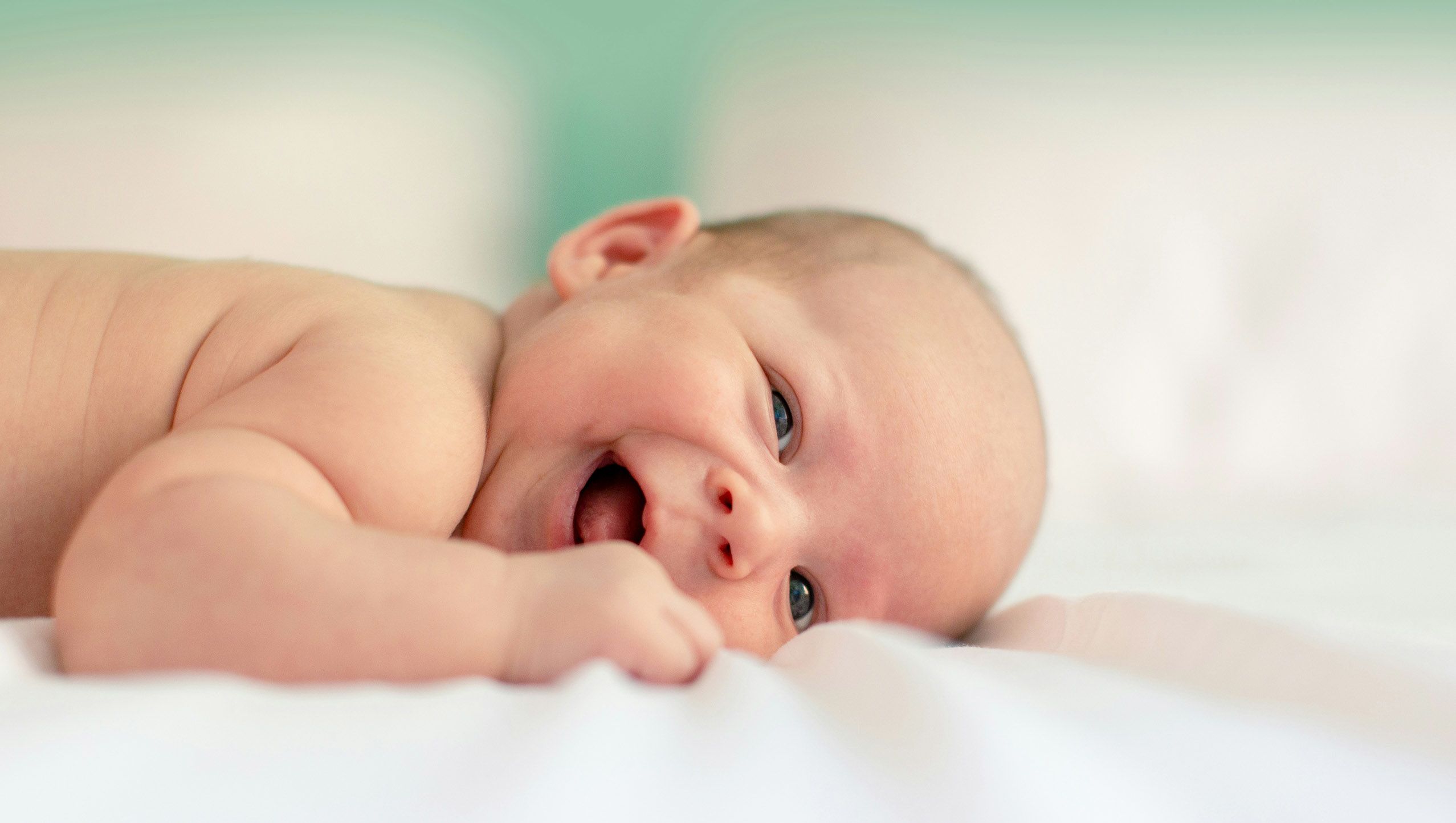 baby lying on fabric cloth